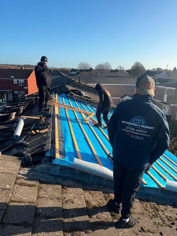 The 247 Roofing team on a roof